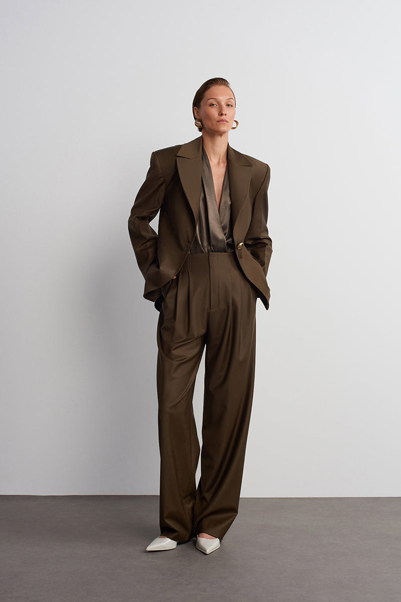 Dark brown Earth Pants by Acaria Studio, tailored fit with visible stitching and waistband, laid flat against a neutral background.