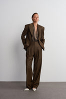 Dark brown Earth Pants by Acaria Studio, tailored fit with visible stitching and waistband, laid flat against a neutral background.