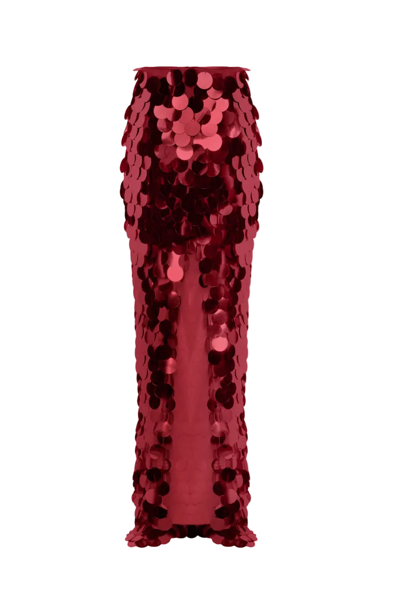 BalYKINA burgundy sequined maxi skirt with flowing fabric and elegant design, displayed hanging with a smooth backdrop.