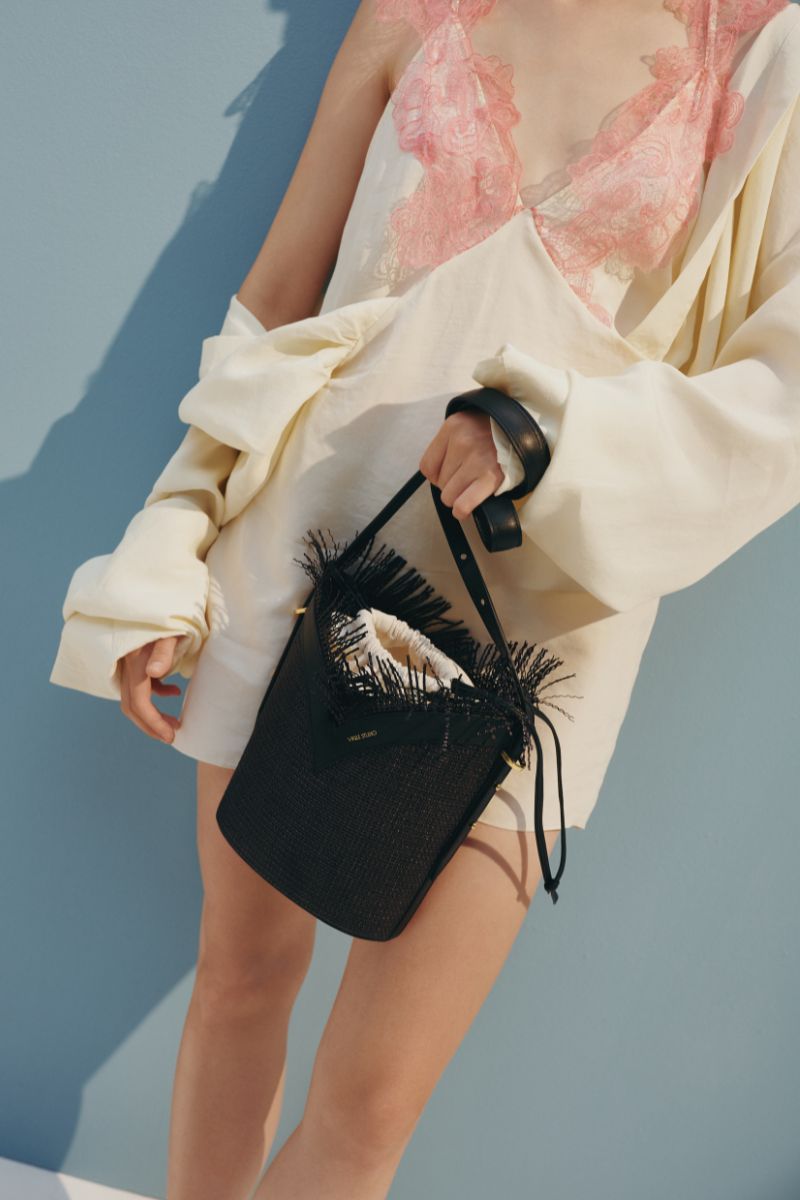 Black VIKELE STUDIO bucket bag with shoulder strap, showing the stylish design and compact size.