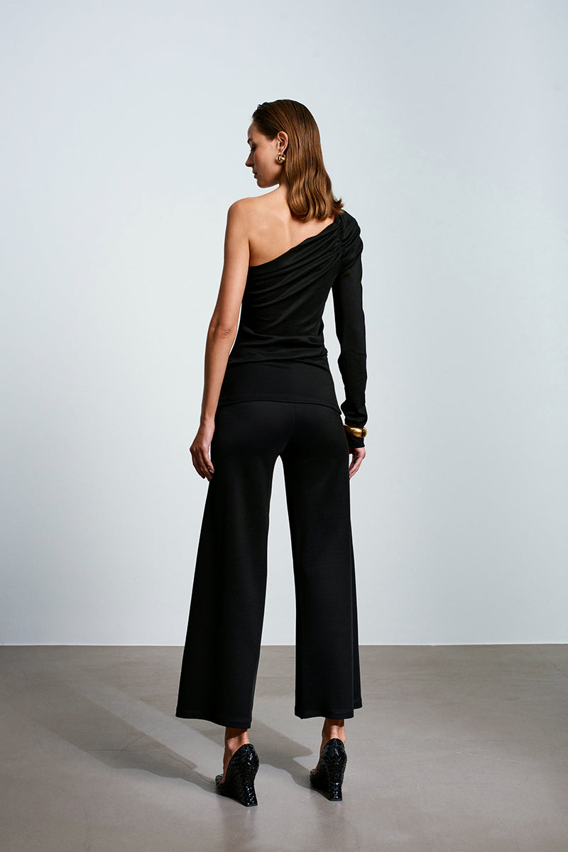 Black top from Acaria Studio's Umbra Top collection, featuring a stylish, fitted design with a round neckline and long sleeves.