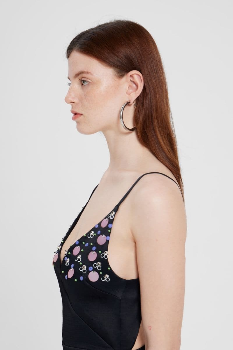 Black embroidered V-neck top by Nara Niro featuring intricate embroidery and a stylish V-neck design, worn on a model.