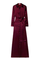 SemSem burgundy silk maxi dress with a flowing, elegant design, shown hanging on a wooden hanger.