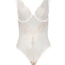 White OOLOG Bodysuit by Entos displayed on a model, showcasing its fitted design and smooth fabric.
