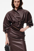 Kris Marán chocolate brown kimono leather jacket, stylish and fitted, displayed on a hanger with a smooth leather texture.