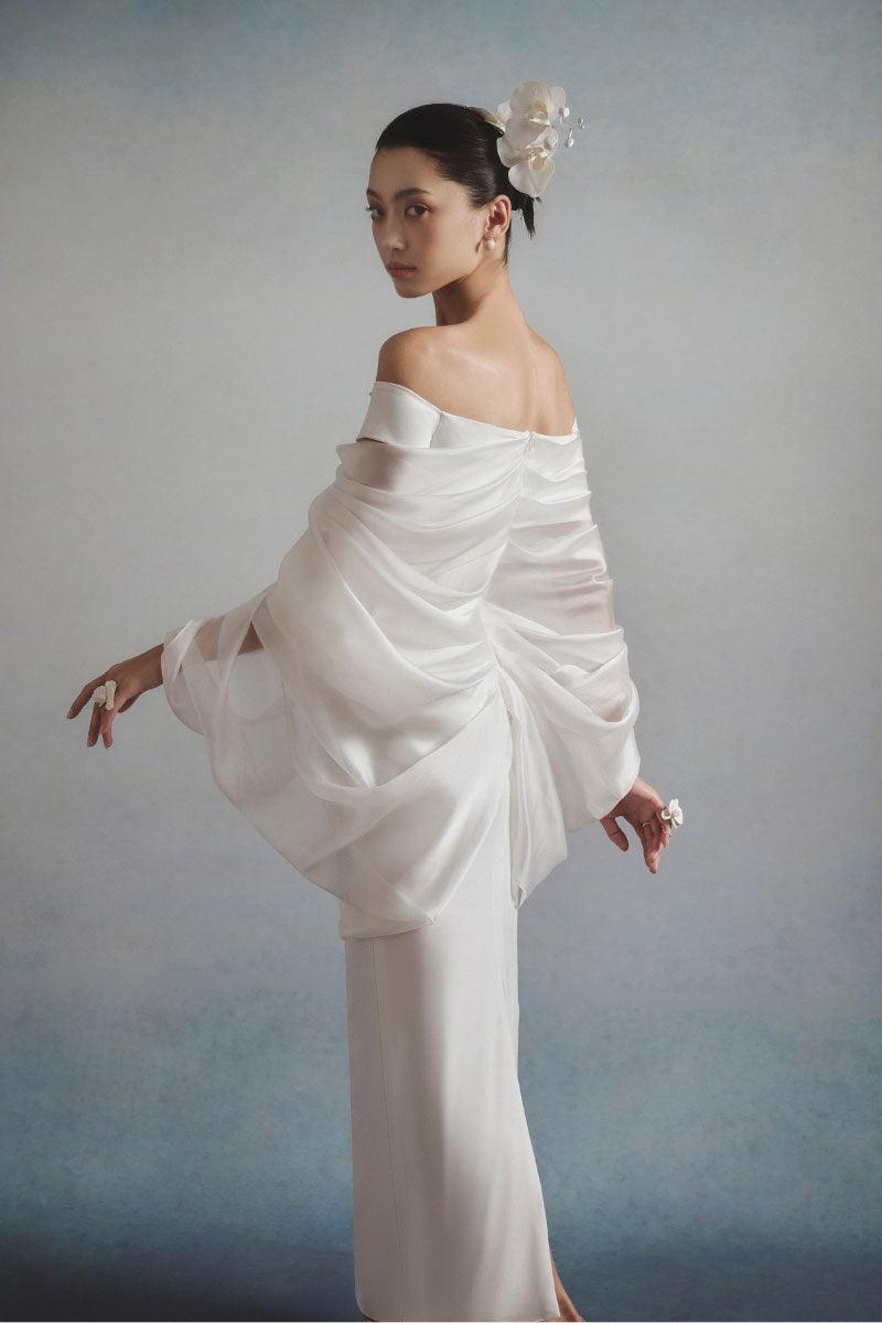 White Plan ELYSIA draped midi dress displayed on a mannequin with flowing fabric and elegant design.
