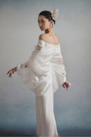 White Plan Elysia Draped Dress gown with flowing fabric and elegant design, shown on a mannequin.