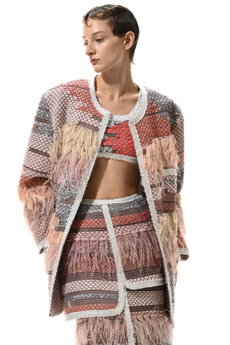 Lalo Avril maxi skirt in red multi with flowing fabric and vibrant pattern, displayed on a hanger against a plain background.