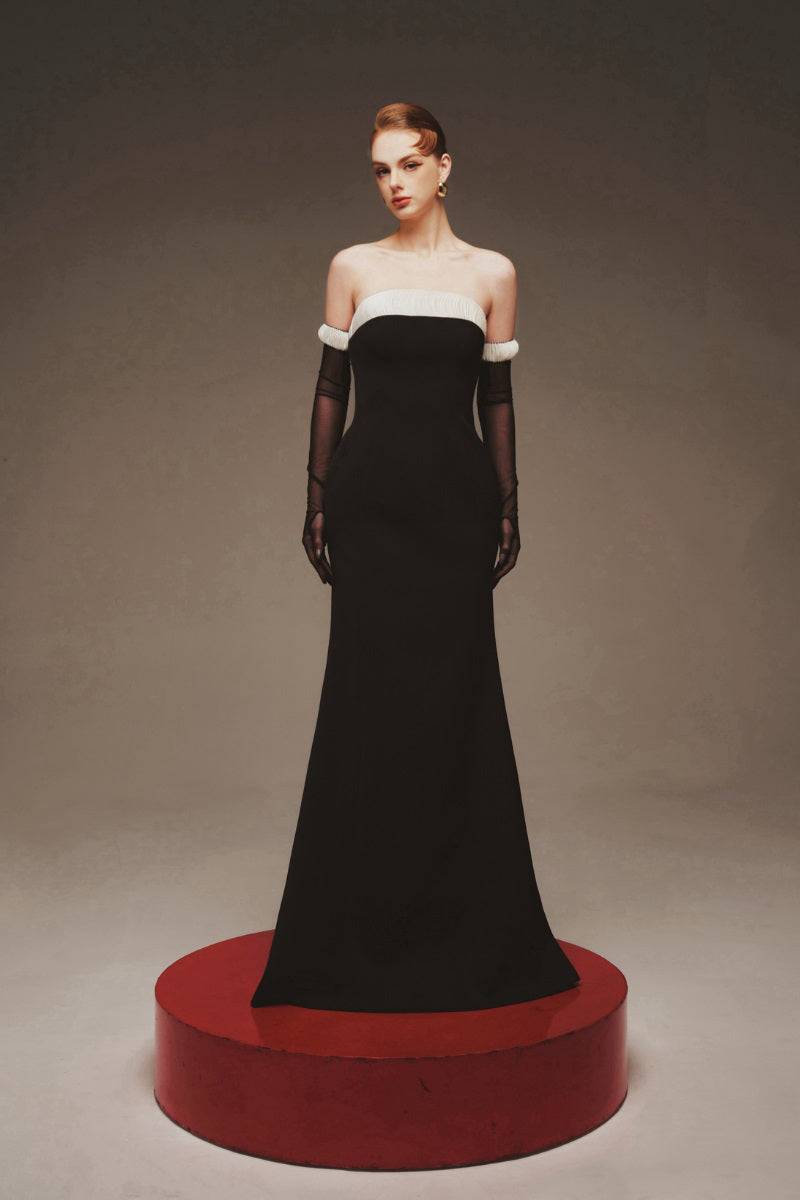 Elegant black Vesper evening gown by Margée Atelier, featuring a flowing maxi dress with intricate detailing and a fitted waist.