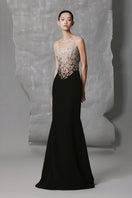 Black Phan Huy long straight gown with a round-neck design, elegant and flowing fabric for formal occasions.