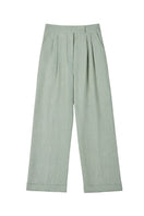 Dāl the Label linen wide-leg pants in natural beige fabric, featuring a relaxed fit and high waistband.