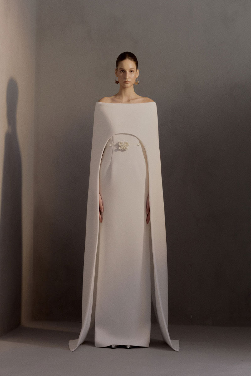 White Plan Legacy Dress gown with elegant fabric and intricate design, displayed hanging on a mannequin.