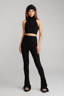 Nana Jacqueline Janelle black knit pants displayed on a model, showcasing their fitted design and soft knit fabric.