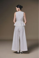 White wide-leg pants by Keira Tong displayed on a model, showcasing the relaxed fit and flowing fabric.