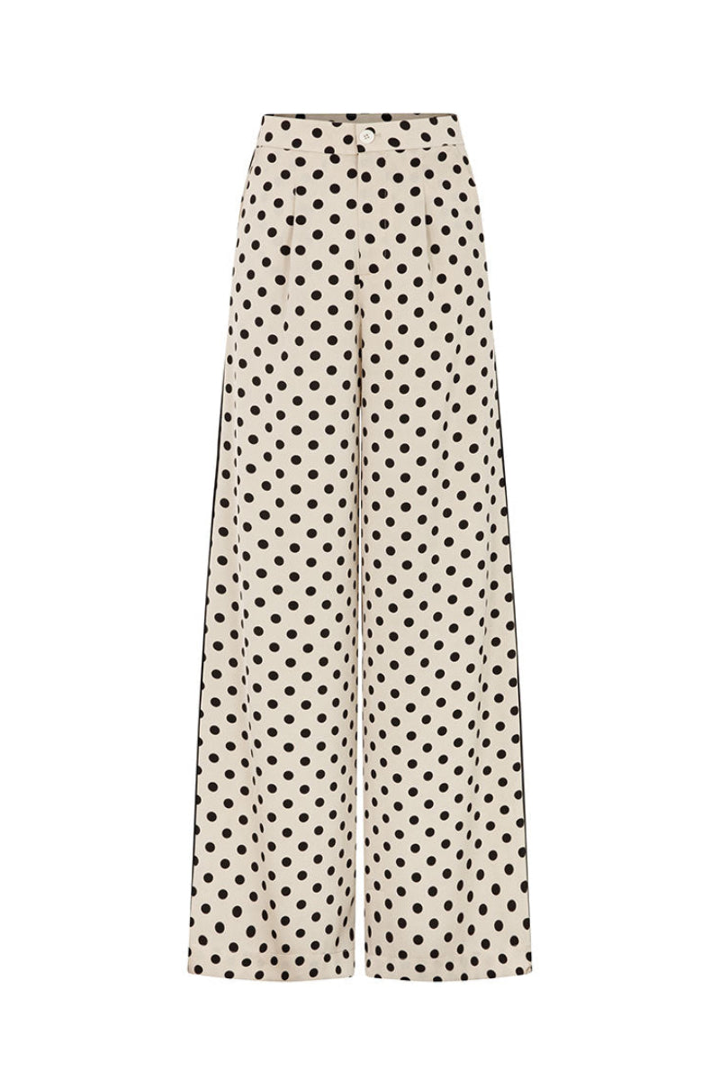 Valenciani loose fit cream trousers with relaxed fit and wide-leg style, shown on a model.