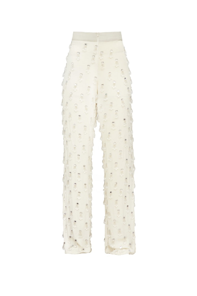 White beaded pants by Onalaja featuring intricate beadwork and a stylish, modern design.