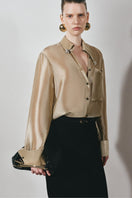 Black Leicia long pencil maxi skirt displayed on a hanger, showcasing its sleek, fitted design and smooth fabric.