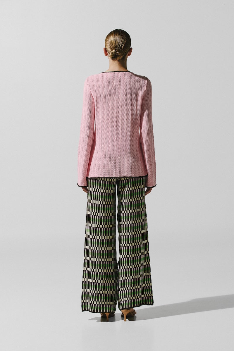 Baobab Kina pants in Disco Rosa with vibrant pink fabric and stylish fit, displayed on a hanger.