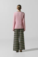 Baobab Kina pants in Disco Rosa with vibrant pink fabric and stylish fit, displayed on a hanger.