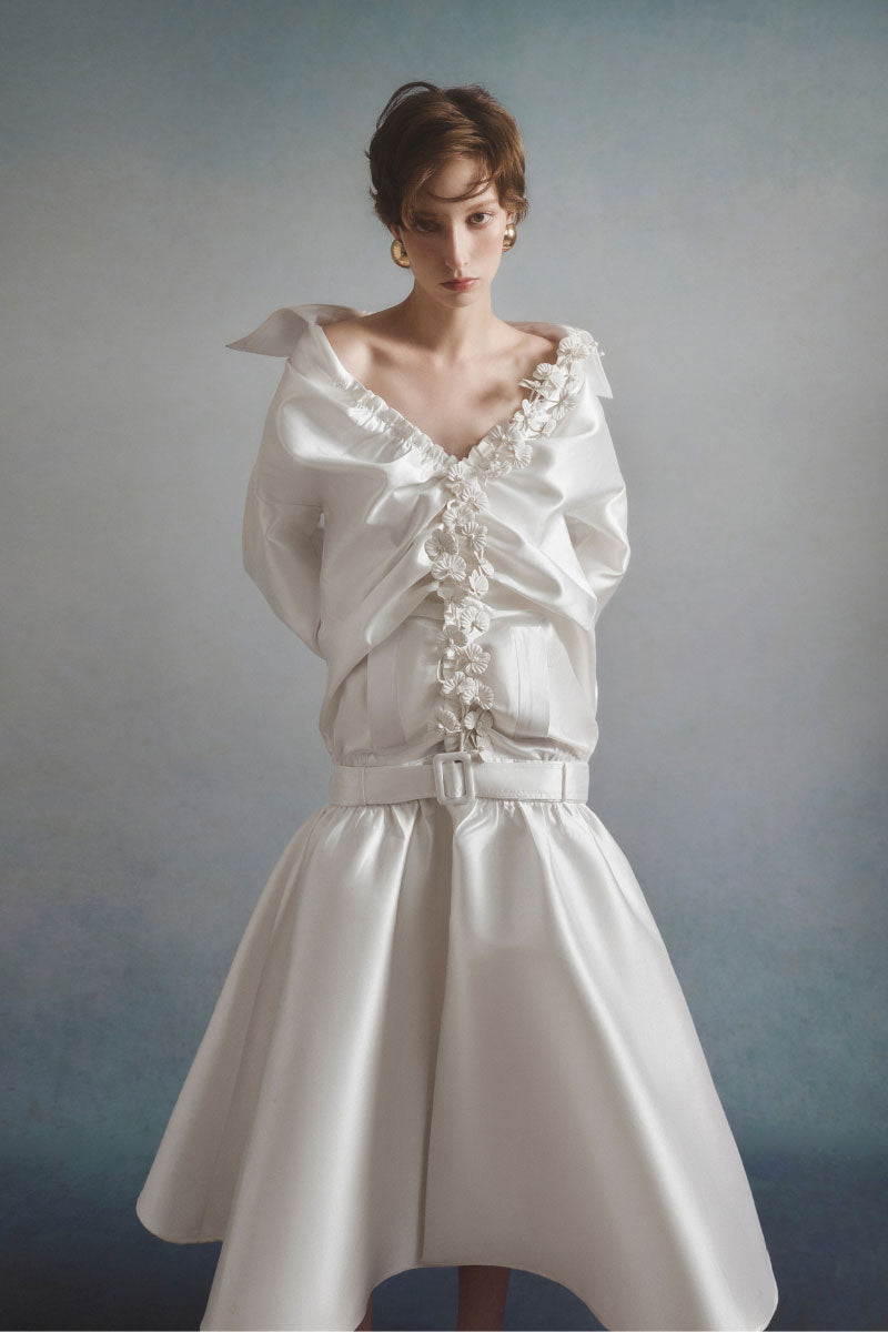 White Plan Valeria belted coat shown on a model, featuring a stylish design, belt at the waist, and classic coat silhouette.