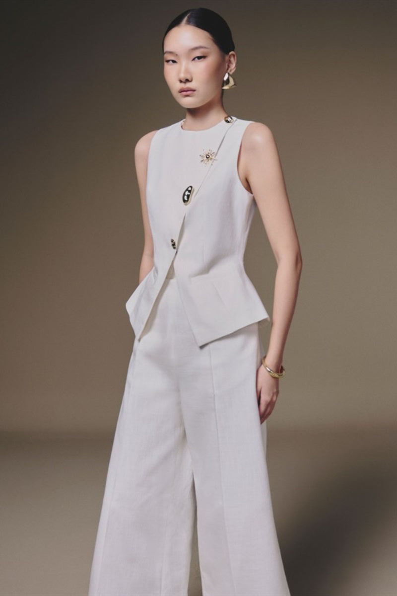 White wide-leg pants by Keira Tong, featuring a relaxed fit and full-length design, shown on a model.