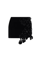 Black floral mini skirt by Lecia featuring a fitted waist and vibrant flower print, perfect for casual or dressy outfits.