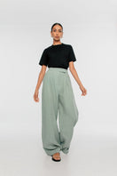 Light beige linen wide-leg pants by Dāl the Label, shown folded on a white background.