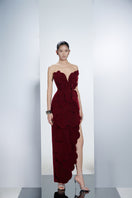 Red velvet V-neck petal strapless gown by Happy Clothing, featuring a flowing silhouette and elegant design.