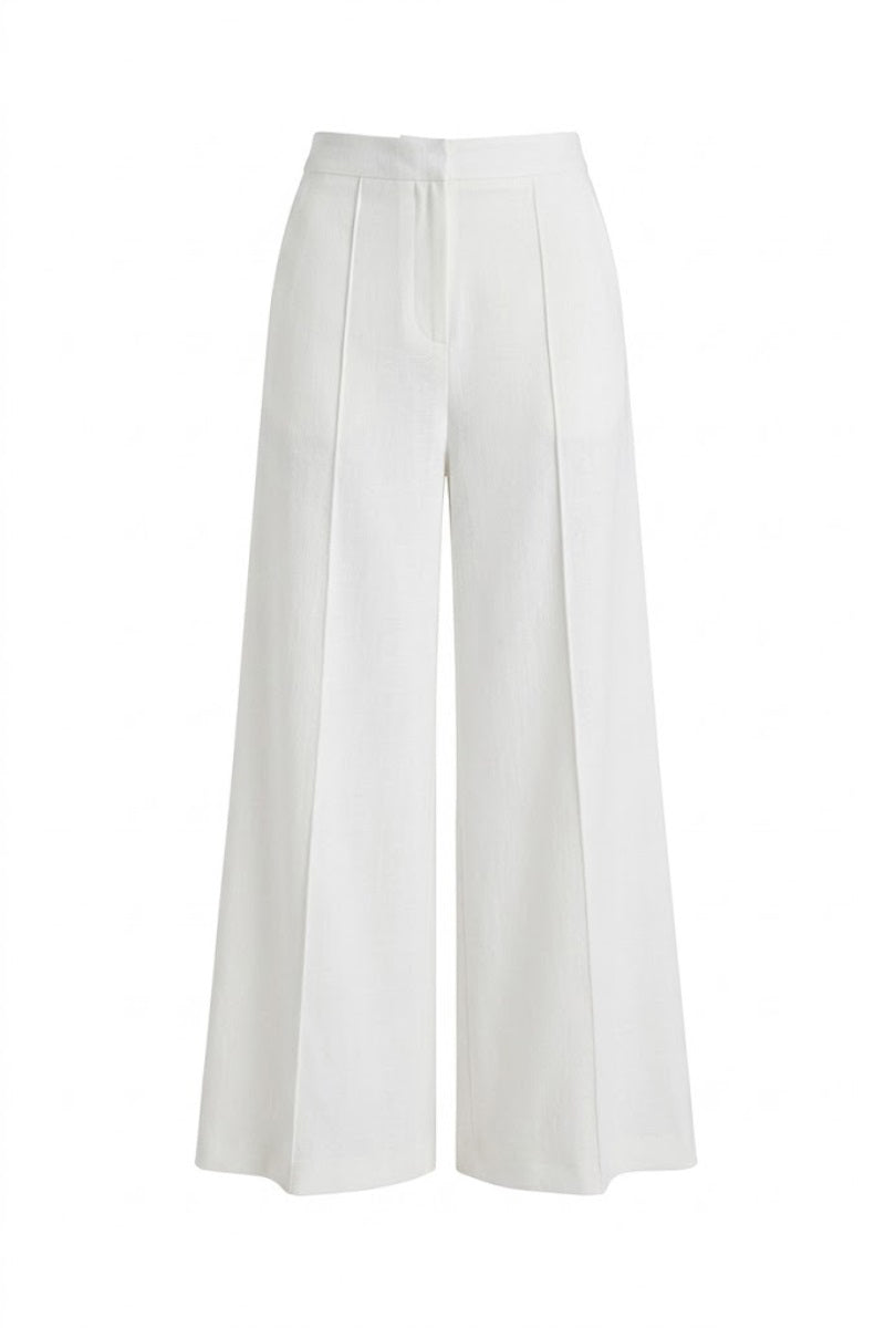 White wide-leg pants by Keira Tong displayed on a flat surface, showcasing the relaxed fit and clean design.