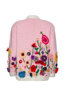 Lalo Floris pink embroidered oversized cardigan with floral embroidery, cozy knit, and relaxed fit, displayed on a hanger.