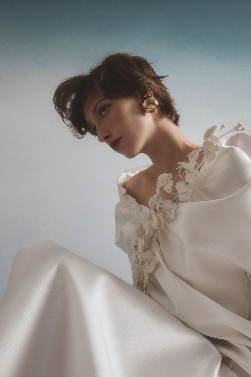 White Plan Valeria belted coat displayed on a hanger, featuring a tailored design and belt at the waist for a stylish winter look.