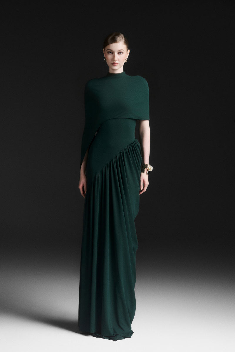 Maison Des Copains green ruched floor-length maxi dress displayed on a model, featuring elegant draping and a fitted waist.