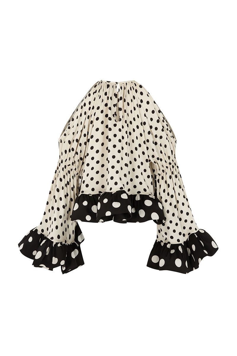 Cream Valenciani voluminuous ruffle sleeve top with puffed sleeves and delicate fabric details.