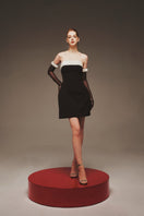 Margée Atelier Monochrome Muse Dress mini dress in sleek black fabric with minimalist design and fitted silhouette.
