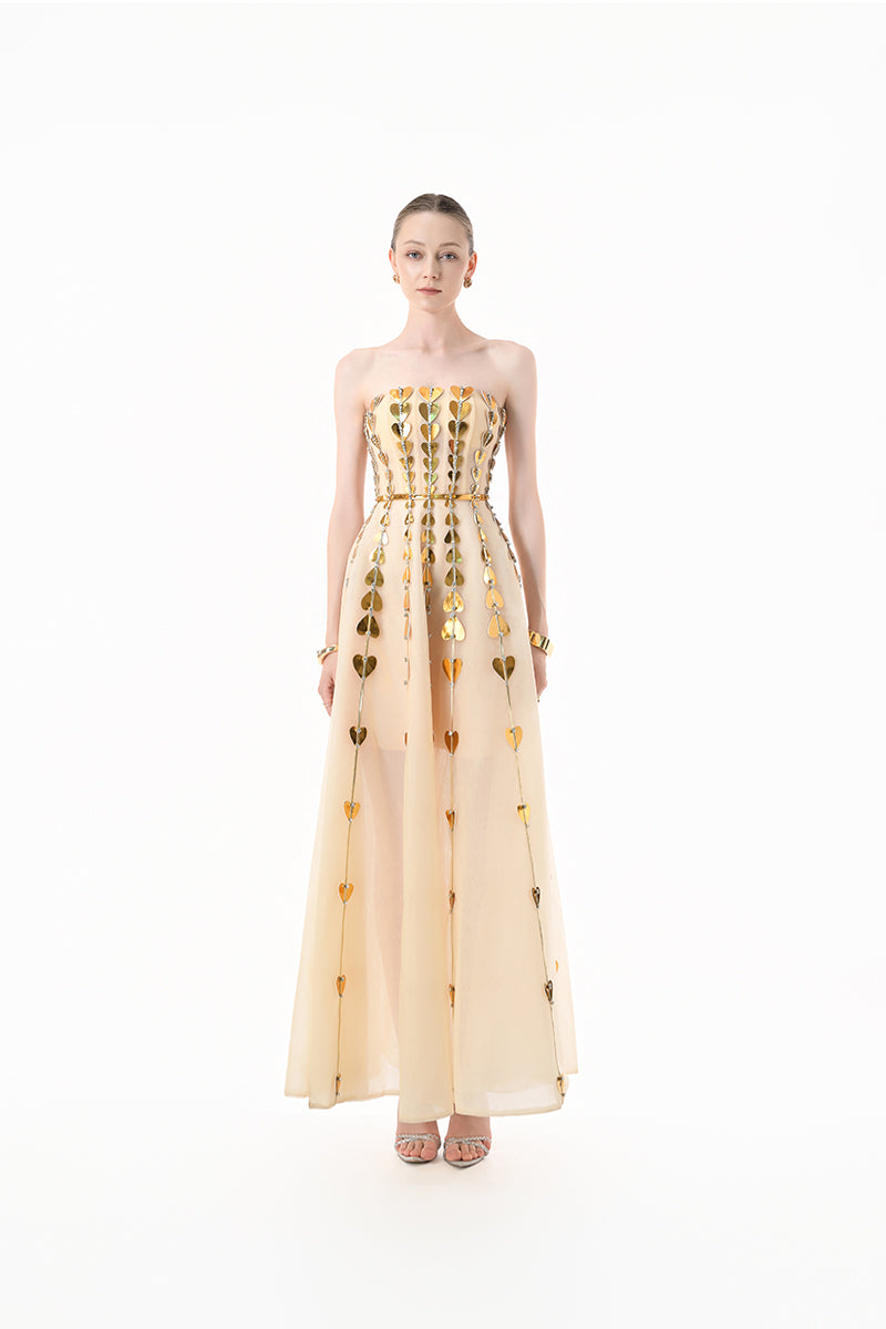 Elegant champagne metallic heart-embellished gown by Happy Clothing, featuring a flowing design and intricate heart details.
