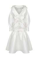 White Plan Valeria belted coat hanging on a wooden hanger, showcasing its tailored design and belt detail.