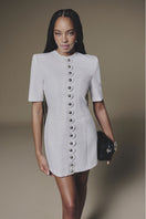 White buttoned mini dress by Keira Tong featuring a fitted silhouette and short sleeves, perfect for casual or semi-formal wear.