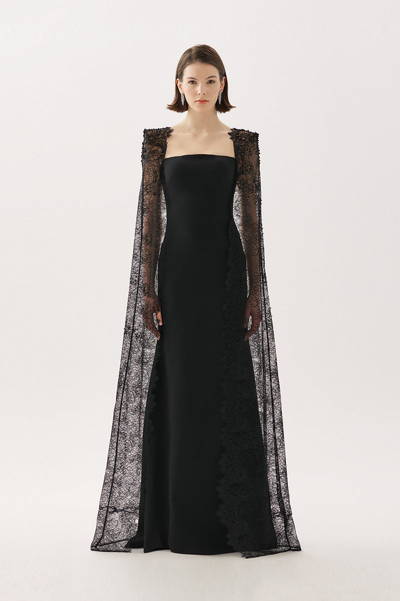 Black Tarık Ediz BELANIS maxi dress featuring elegant fabric and a flowing silhouette, displayed on a hanger.