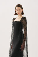 Elegant black gown from Tarık Ediz's BELANIS collection, featuring a flowing silhouette and detailed fabric design.
