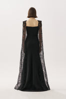 Black Tarık Ediz gown with elegant design, featuring flowing fabric and intricate details for formal occasions.