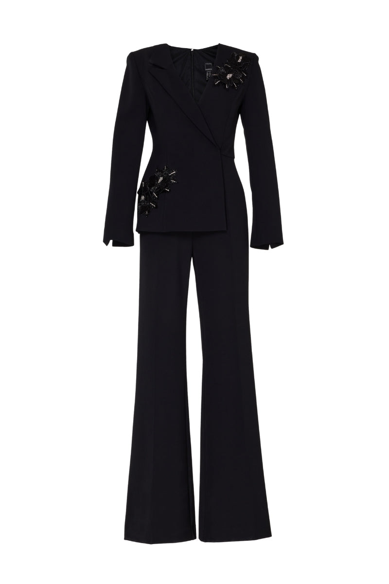 Black Tarık Ediz IRENI jumpsuit displayed on a ghost mannequin, showcasing the front view of this stylish one-piece outfit.