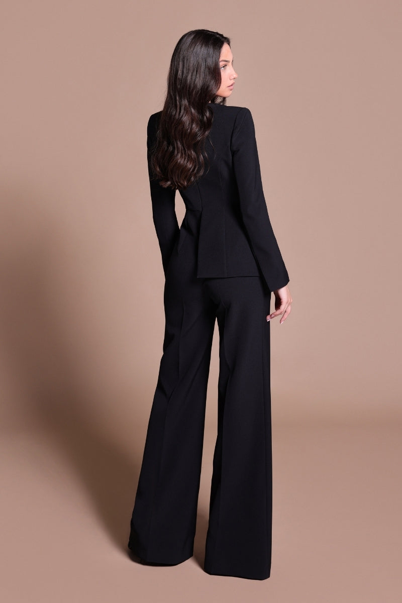 Black Tarık Ediz IRENI jumpsuit displayed from the back, showcasing a stylish, fitted design with sleek lines and elegant details.