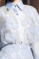 21Six Felicia blue shiny silk floral co-ords set with matching shirt and skirt, featuring a glossy finish and vibrant floral pattern.