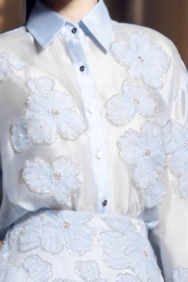 21Six Felicia blue shiny silk floral co-ords set with matching shirt and skirt, featuring a glossy finish and vibrant floral pattern.