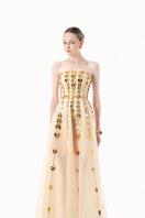 Elegant champagne metallic gown with heart embellishments from Happy Clothing, featuring a flowing design and intricate detailing.