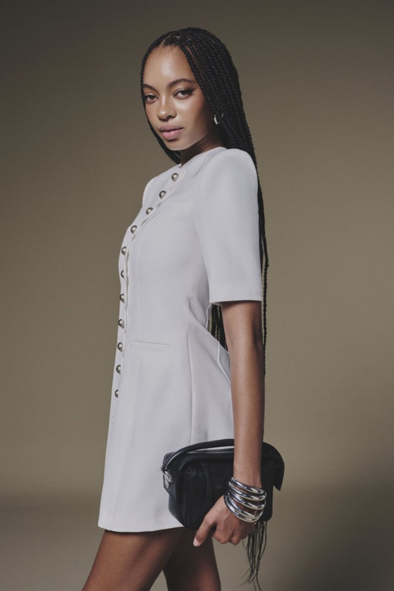 White buttoned mini dress by Keira Tong with a fitted silhouette and short sleeves, displayed on a neutral background.