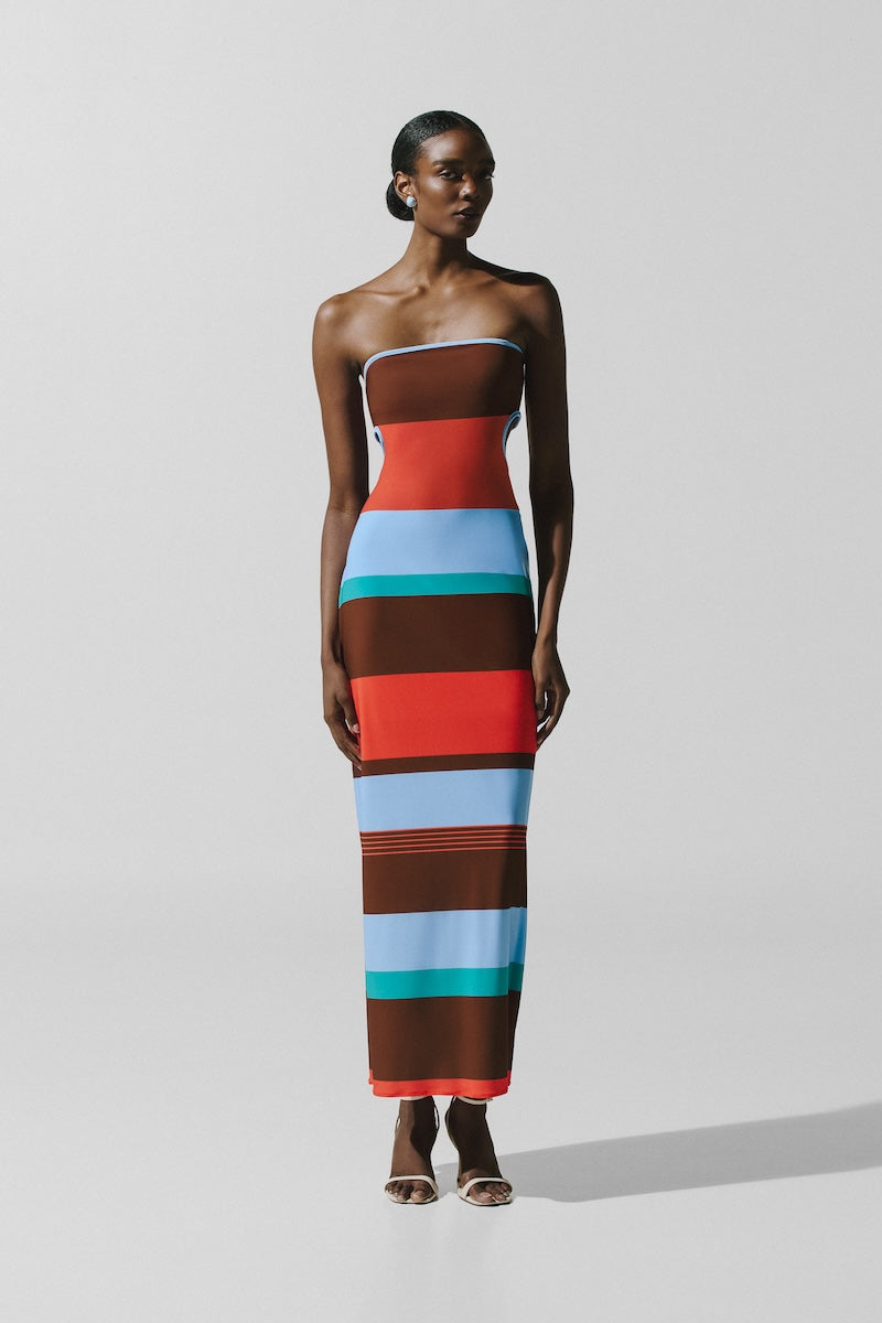 Baobab Mambo Maxi Dress in Funky Aperol fabric featuring vibrant patterns and flowing silhouette, perfect for casual or summer wear.