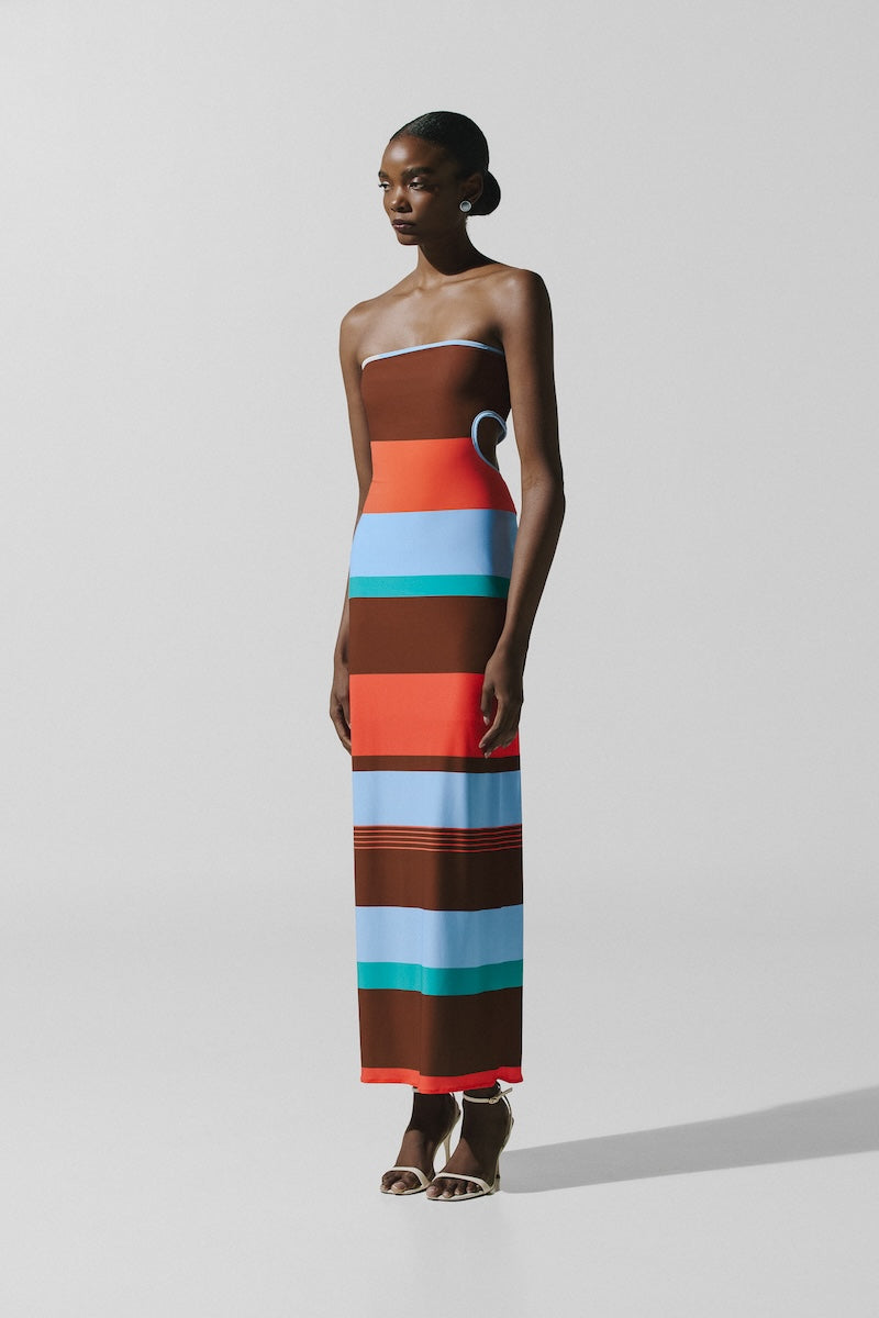 Baobab Mambo Maxi Dress in Funky Aperol with vibrant floral pattern, flowing fabric, and stylish sleeveless design.