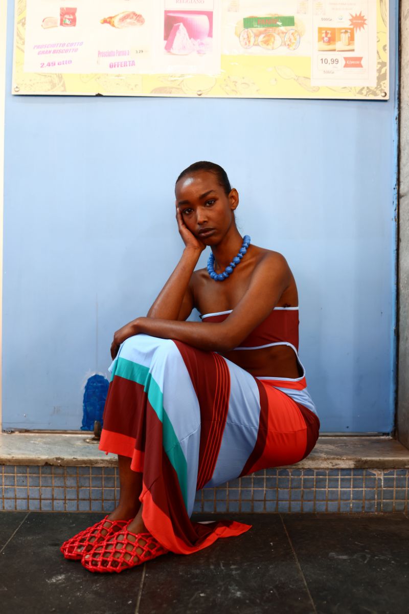 Baobab Mambo Maxi Dress in Funky Aperol with vibrant pattern, flowing fabric, and sleeveless design for stylish summer wear.