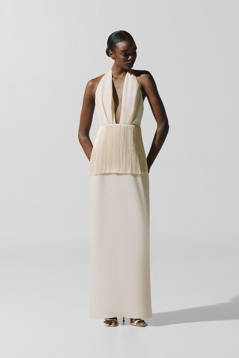 Baobab Paloma Maxi Dress in Mascarpone fabric displayed on a hanger, showcasing its elegant, flowing design and soft cream color.